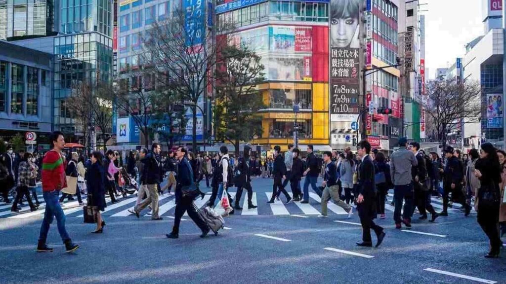 Many people crossing a crowded street