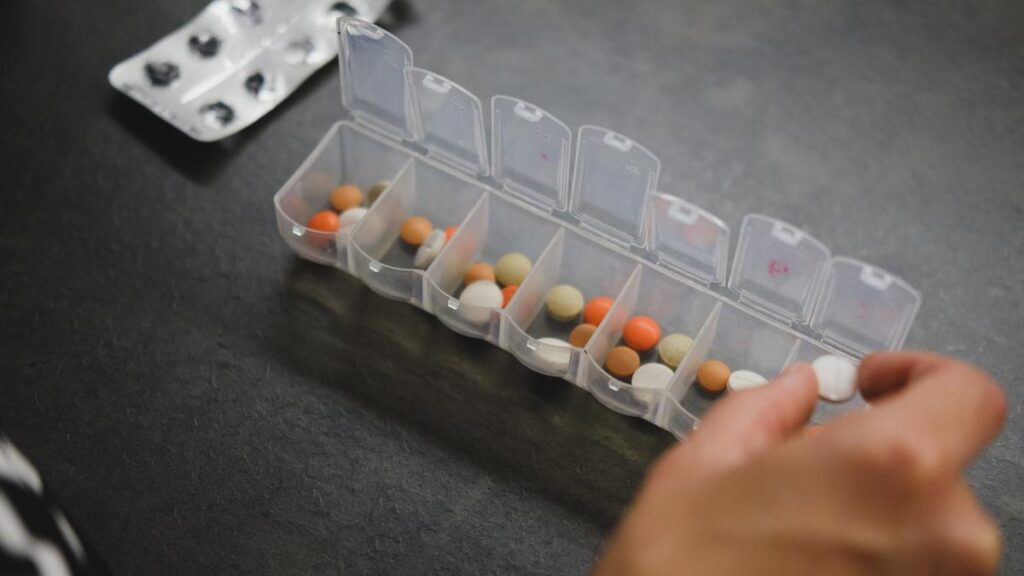 Woman filling up a medicine organizer