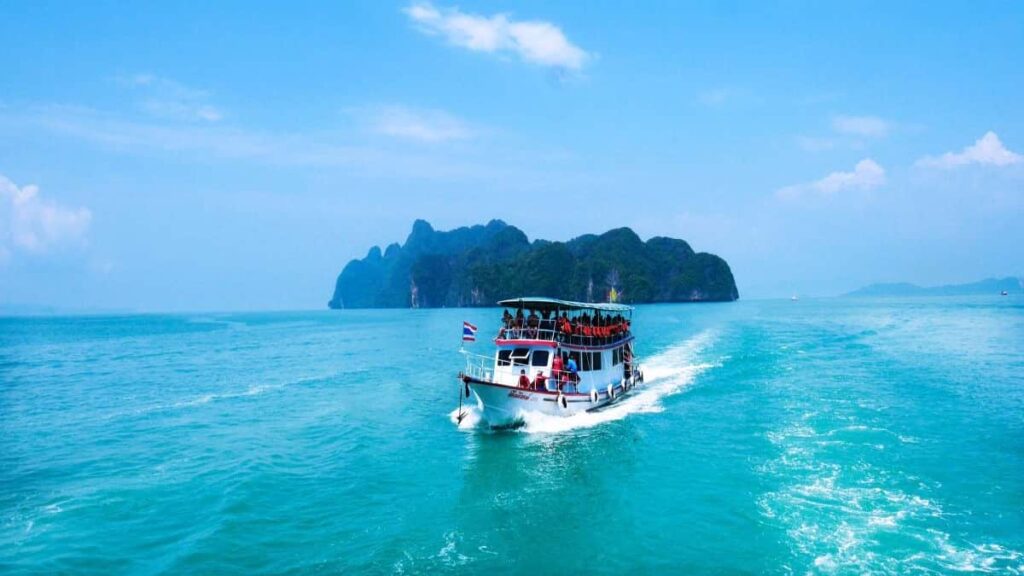 Crowded boat on the blue sea on its way to a Thai island