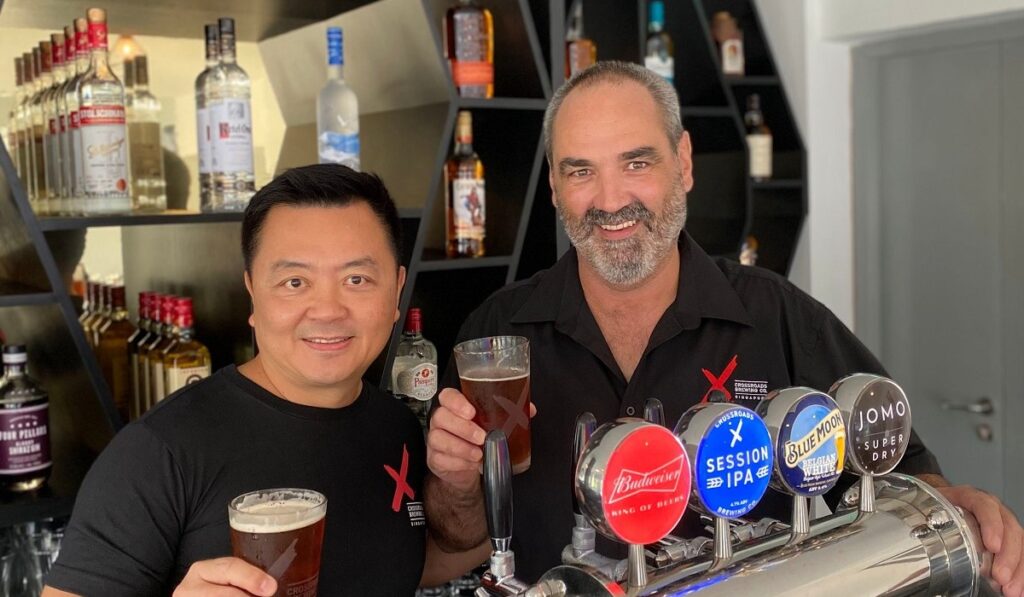 Adrian Sim from East Asia Beverages and Jim Kellett, CEO of Crossroads Brewing Company Singapore (CBCS)