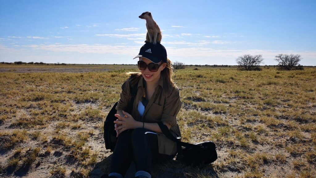 Sheena Sim chilling with a meerkat in Makgadikhadi Pan, Botswana